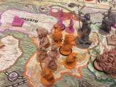 beige, orange and grey plastic miniatures on a game board of Rising Sun