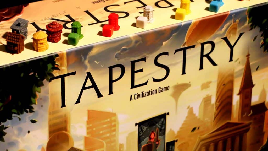 a close-up of the Tapestry game box with some plastic components on top (Photo courtesy of Stonemaier Games)