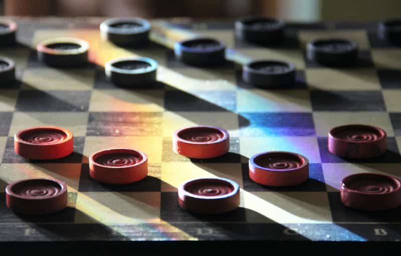a board of draughts (Photo by Leonard Reese on Unsplash)