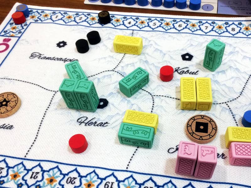 Pax Pamir: Second Edition's cloth board, colour resin block and wooden cylinders