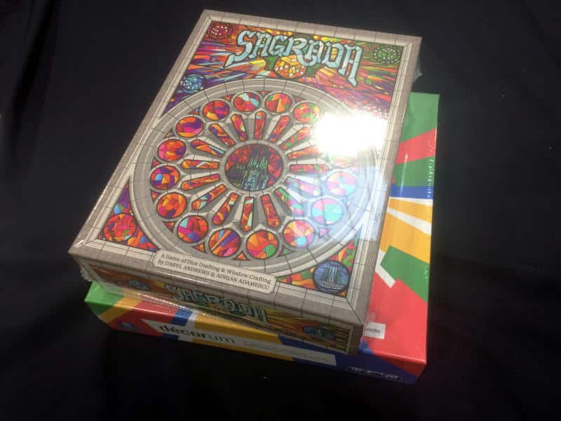 A shrink-wrapped copy of Sagrada on top of the decorum