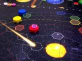 Plutocracy game board with coloured discs representing the planets