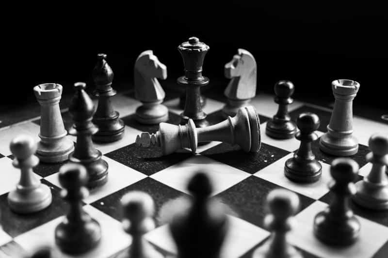 a chess game with chess pieces and the white king on its side (Photo by Felix Mittermeier on Unsplash)