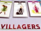 the edge of the Villagers playmat an three basic villager card decks
