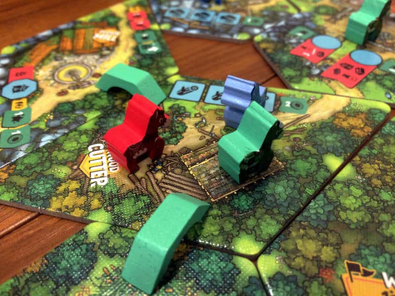 a green, red and blue donkey on a village tile, with two green bridges connecting to more tiles