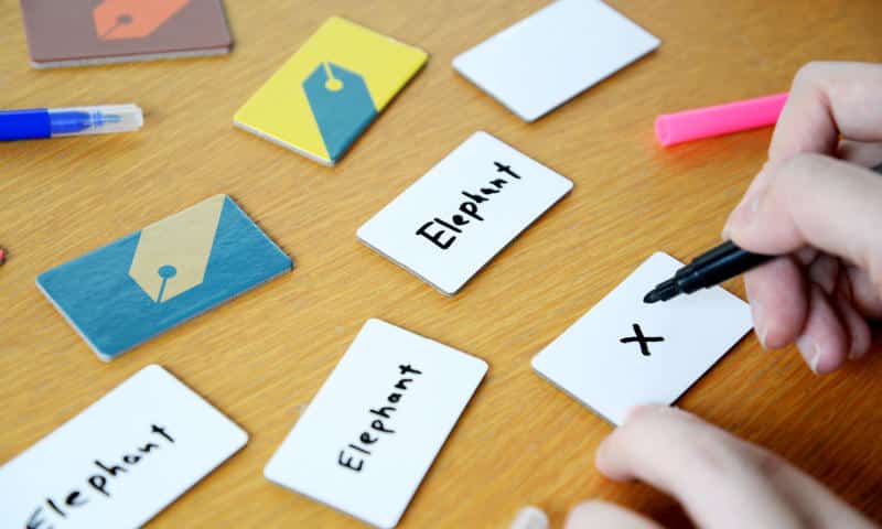 some of the word tiles with a word written on them and one with a cross (Photo courtesy of Oink Games)