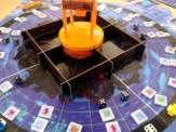 the plastic dice tower in the shape of an orange drill platform, some of the oil dice, animal tokens, etc.