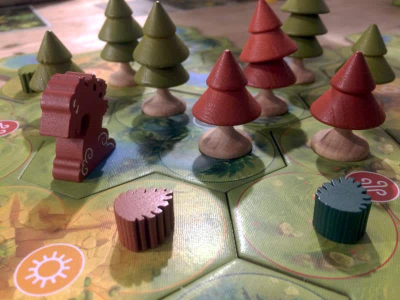 the custom wooden spirit meeple, the wooden trees and seed tokens from Forests of Pangaia