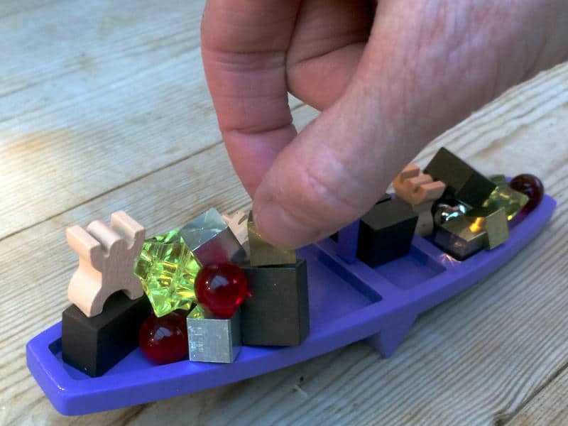 a hand trying to place golden cube onto the Viking See-Saw