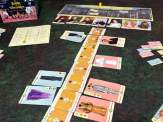 the game's "runway" tiles with cards played either side