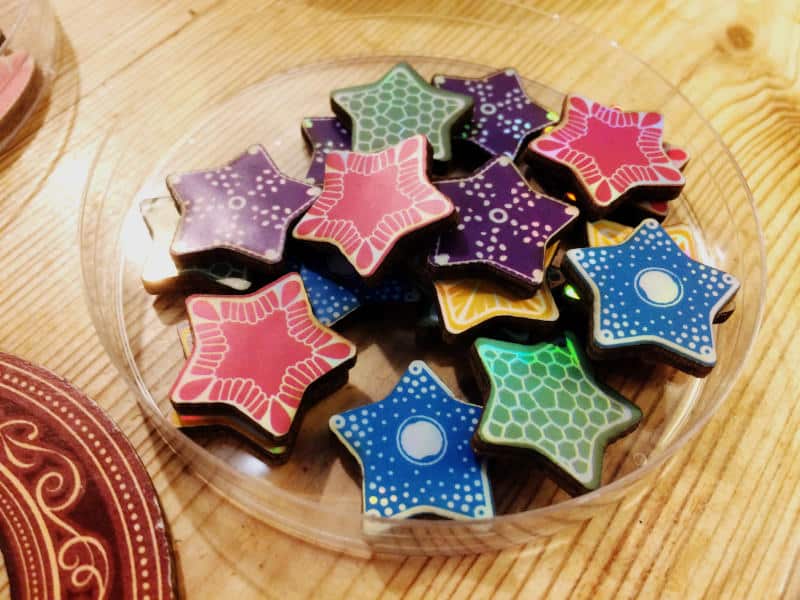 sparkly, star-shaped diatom tokens in a plastic Petri dish (prototype components shown)