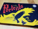 the box for Portents with clean and simple artwork in bright yellow and dark blue, showing a bird and a cat and the word Portents
