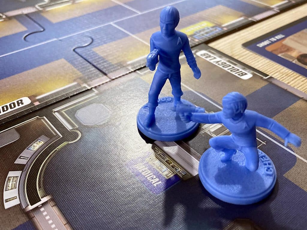 a close-up of the Commander Spock and Chekov miniatures on the game board