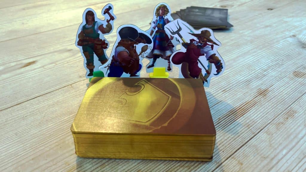 four cardboard character standees and the deck of loot cards with gold edge