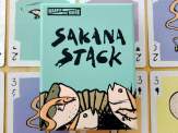 the box of Sakana Stack on top of some of the cards from the game