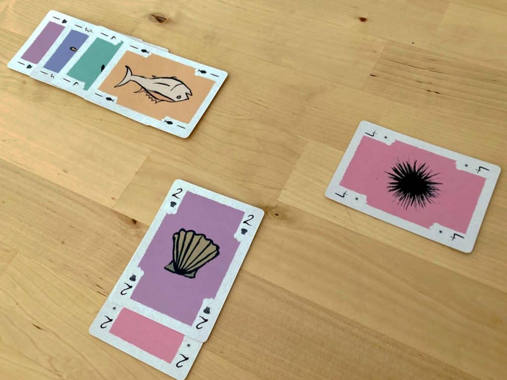 three matching stacks of cards from Sakana Stack all adding up to a value of 4