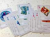 the deck of Mysticana cards splayed out showing off the artwork for the three suit colours