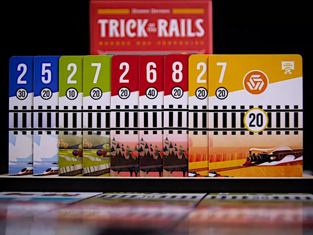 some of the cards from Trick of the Rails with the box cover in the background