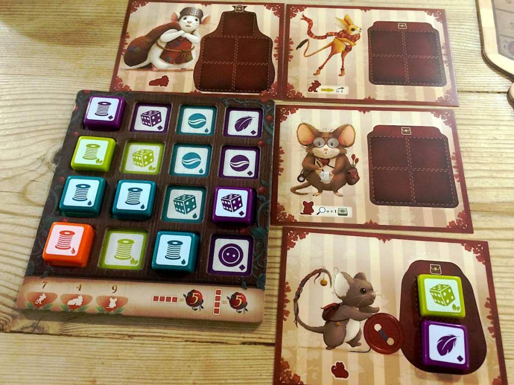 a close-up of the four mice boards and the main player board with a number of tiles