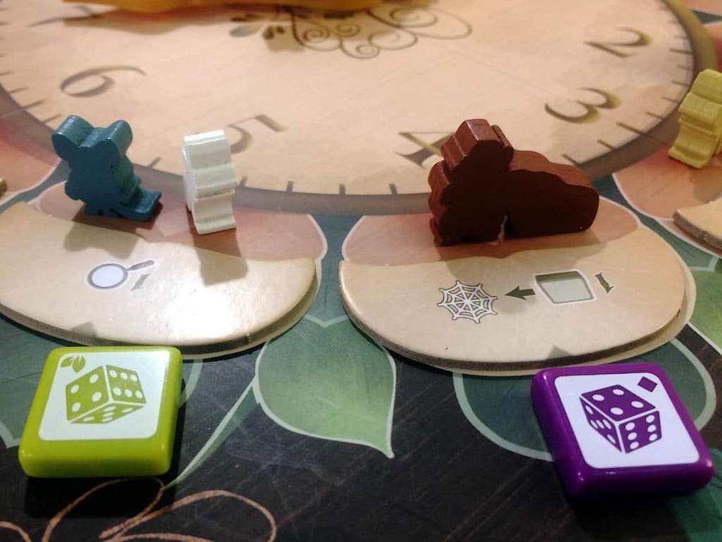 a close-up of some of the actions around the clock and three mouse tokens and two tiles