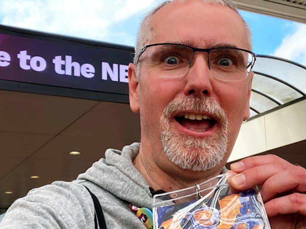 a selfie of me with my press badge in front of the NEC's main entrance