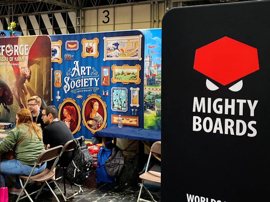the Mighty Boards banner on the right and people playing games in the background