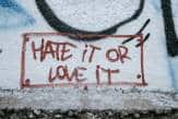 graffiti on a wall that says HATE iT OR LOVE iT