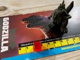 a Godzilla miniature on top of the Godzilla player board