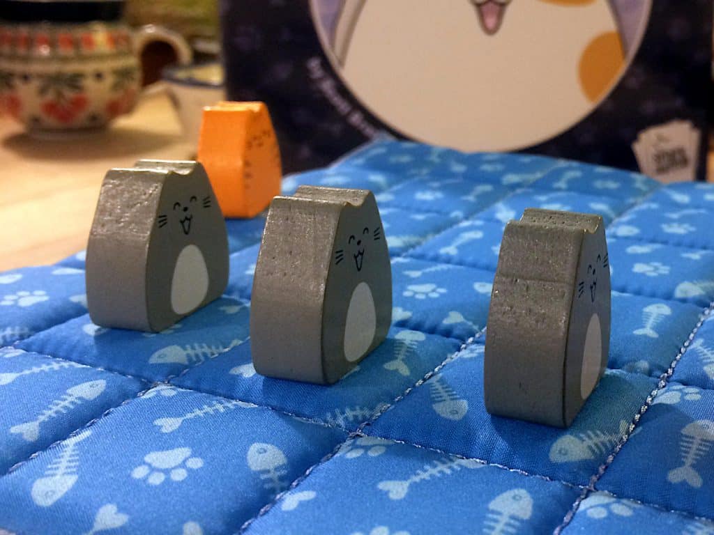 three grey cat meeples lined up